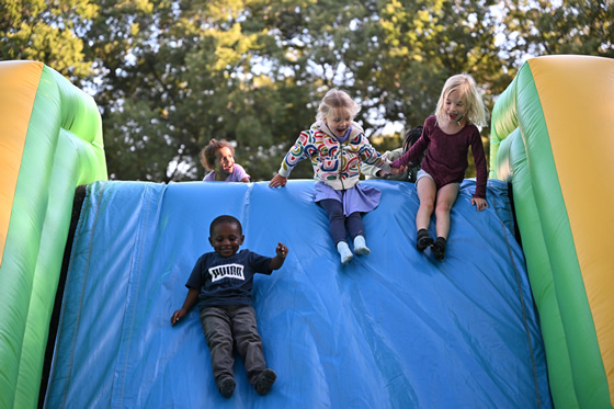 Kids sliding down an inflatable slide